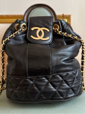 CHANEL Black Quilted Lambskin Drawstring Backpack with Gold CC Accent